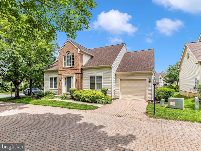 2409 Bear Den Rd, Frederick, MD 21701 - traditional-style home featuring an attached garage, decorative driveway, roof with shingles, and brick siding