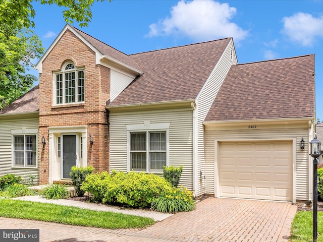2409 Bear Den Rd, Frederick, MD 21701 - traditional-style home with an attached garage, roof with shingles, decorative driveway, and brick siding