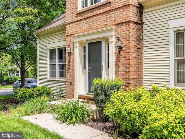 2409 Bear Den Rd, Frederick, MD 21701 - view of exterior entry with brick siding and a shingled roof