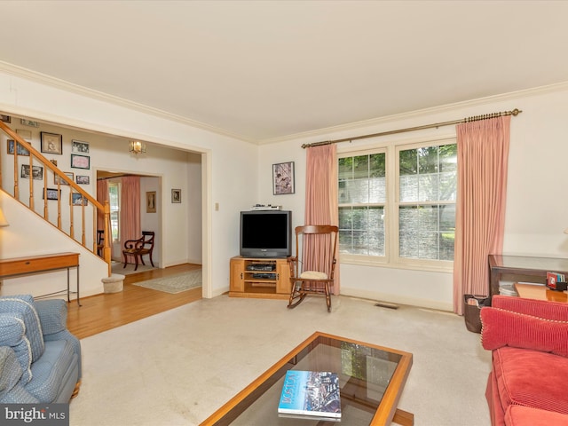 2409 Bear Den Rd, Frederick, MD 21701 - carpeted living area featuring stairway, crown molding, and baseboards