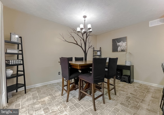 24950 Morgan Rd, Hollywood, MD 20636 - dining room with baseboards, a chandelier, and a textured ceiling