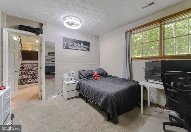 24950 Morgan Rd, Hollywood, MD 20636 - bedroom with wood walls, light colored carpet, and a textured ceiling