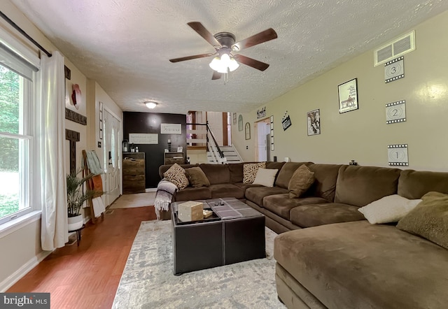 24950 Morgan Rd, Hollywood, MD 20636 - living area featuring ceiling fan, healthy amount of natural light, a textured ceiling, stairs, and wood finished floors