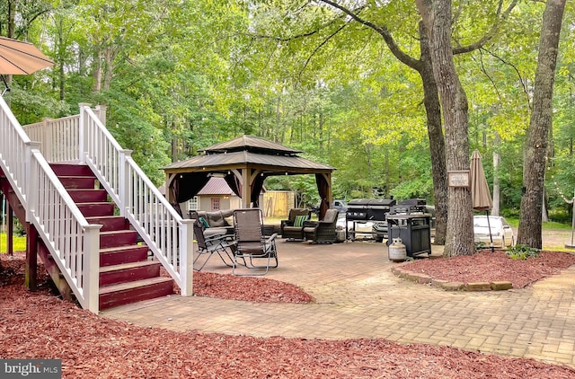 24950 Morgan Rd, Hollywood, MD 20636 - view of patio / terrace featuring a gazebo, an outdoor living space, stairway, and a forest view