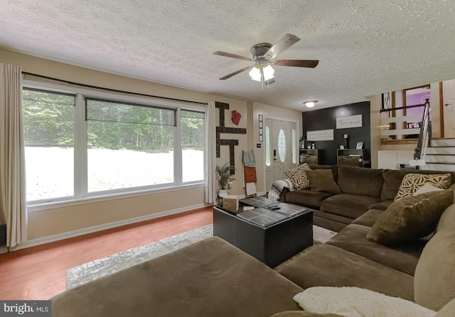 24950 Morgan Rd, Hollywood, MD 20636 - living room with a textured ceiling, wood finished floors, a ceiling fan, stairway, and plenty of natural light