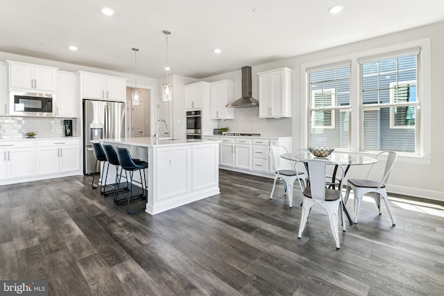 8516 Silver Laurel Ln, Frederick, MD 21704 - kitchen with wall chimney exhaust hood, stainless steel appliances, decorative backsplash, dark wood-style flooring, and recessed lighting