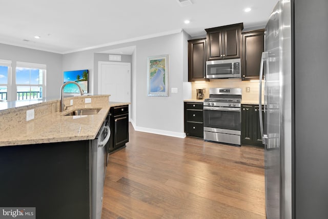 3411 Angelica Way Unit 303, Frederick, MD 21704 - kitchen with stainless steel appliances, a sink, baseboards, crown molding, and backsplash