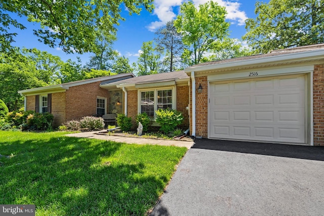 2516 N Haven Cv, Annapolis, MD 21401 - ranch-style house with brick siding, asphalt driveway, a front lawn, and a garage