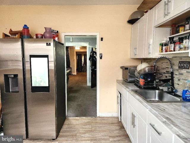 6553 N Smedley St, Philadelphia, PA 19126 - kitchen featuring stainless steel fridge with ice dispenser, a sink, decorative backsplash, white cabinets, and light countertops