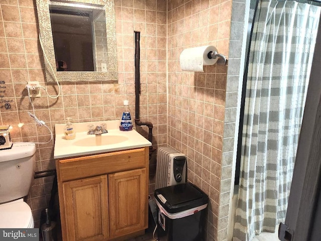 6553 N Smedley St, Philadelphia, PA 19126 - bathroom with tile walls, toilet, vanity, and radiator
