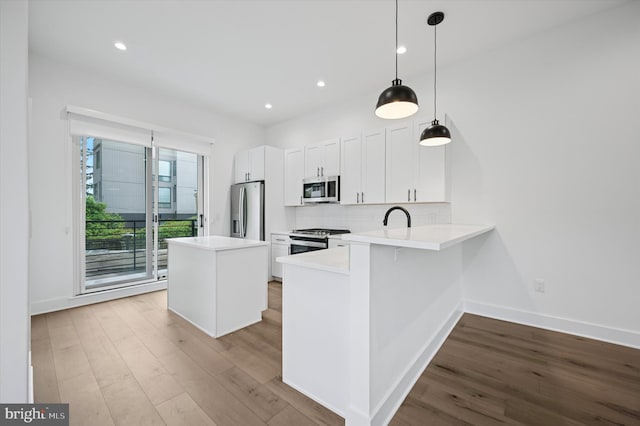6522 Magnolia St, Philadelphia, PA 19119 - kitchen with stainless steel appliances, wood finished floors, light countertops, backsplash, and recessed lighting