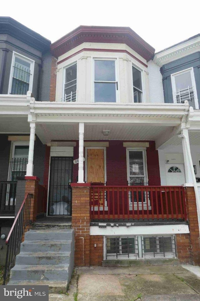 3057 Brighton St, Baltimore, MD 21216 - view of property featuring covered porch and brick siding