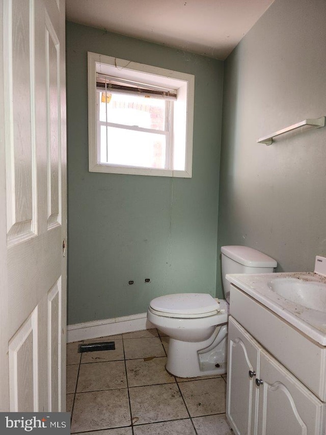 3057 Brighton St, Baltimore, MD 21216 - half bathroom with vanity, toilet, and tile patterned floors