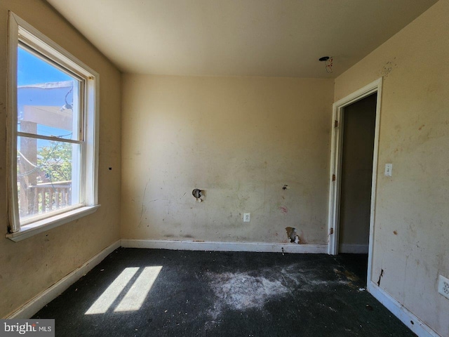 3057 Brighton St, Baltimore, MD 21216 - spare room with unfinished concrete flooring and baseboards