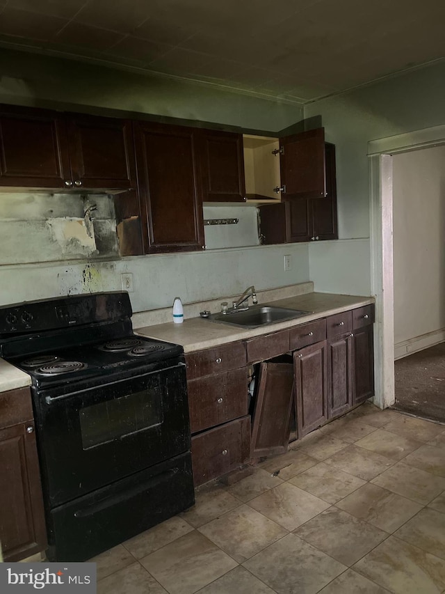 2247 E Cambria St, Philadelphia, PA 19134 - kitchen with black range with electric cooktop, a sink, dark brown cabinetry, and light countertops