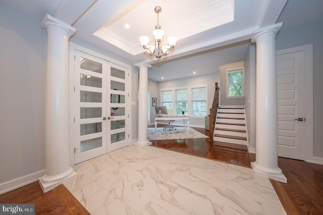 11 Ridings Way, West Chester, PA 19382 - foyer featuring decorative columns, a raised ceiling, a chandelier, baseboards, and stairway