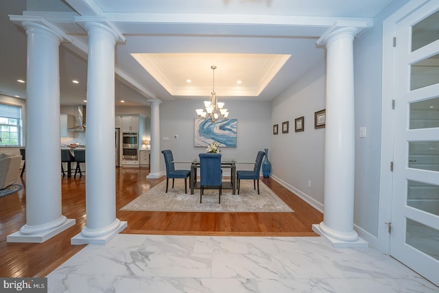 11 Ridings Way, West Chester, PA 19382 - dining space featuring ornamental molding, a tray ceiling, ornate columns, marble look tile flooring, and baseboards