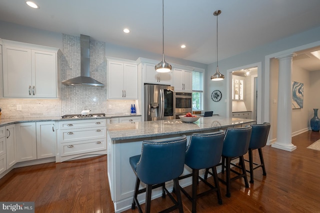 11 Ridings Way, West Chester, PA 19382 - kitchen featuring appliances with stainless steel finishes, wall chimney exhaust hood, decorative columns, white cabinetry, and recessed lighting