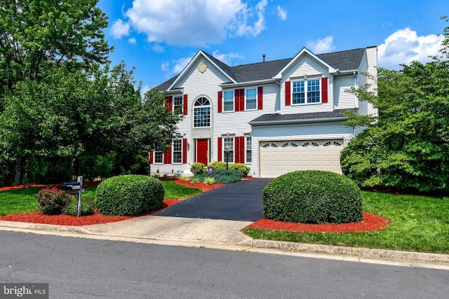 9111 Dartford Pl, Bristow, VA 20136 - view of front of home with an attached garage, driveway, and a front lawn