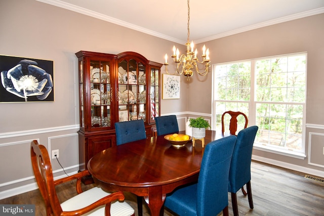 9111 Dartford Pl, Bristow, VA 20136 - dining area featuring a chandelier, crown molding, wood finished floors, wainscoting, and a decorative wall