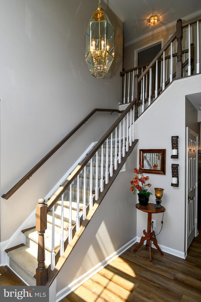 9111 Dartford Pl, Bristow, VA 20136 - staircase featuring wood finished floors, a chandelier, crown molding, and a towering ceiling
