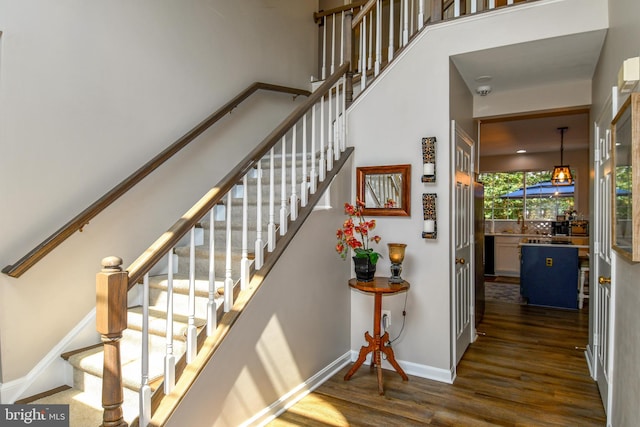9111 Dartford Pl, Bristow, VA 20136 - staircase with wood finished floors and a high ceiling