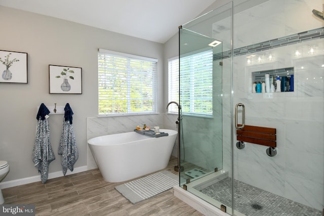 9111 Dartford Pl, Bristow, VA 20136 - bathroom featuring a soaking tub, a stall shower, wood finished floors, and lofted ceiling