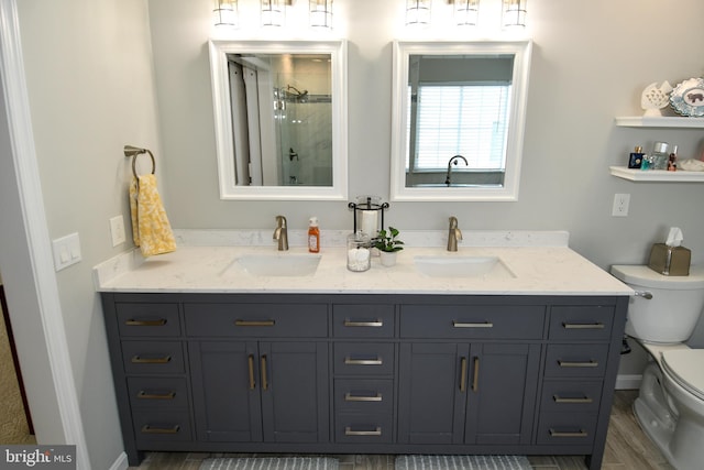 9111 Dartford Pl, Bristow, VA 20136 - bathroom with a shower with shower door, double vanity, and wood finished floors