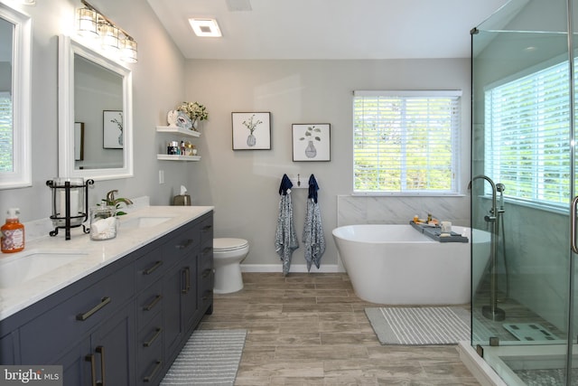 9111 Dartford Pl, Bristow, VA 20136 - bathroom featuring double vanity, healthy amount of natural light, a freestanding tub, and a shower stall