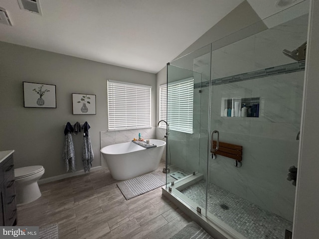 9111 Dartford Pl, Bristow, VA 20136 - full bathroom with vanity, a freestanding tub, vaulted ceiling, and a shower stall