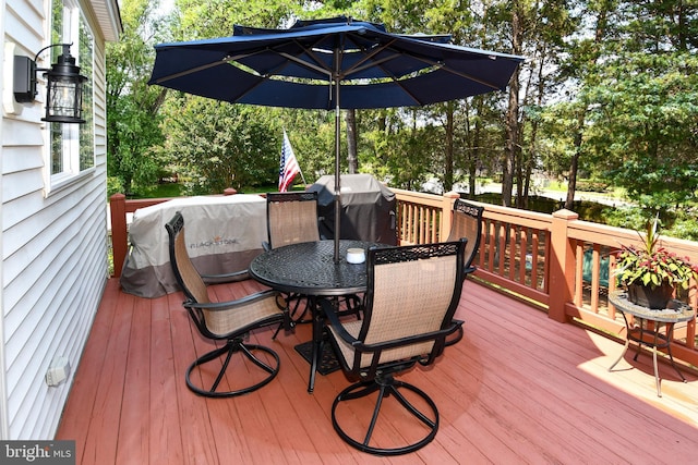 9111 Dartford Pl, Bristow, VA 20136 - deck with outdoor dining space, a grill, and view of scattered trees