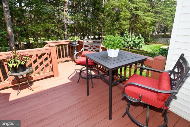9111 Dartford Pl, Bristow, VA 20136 - wooden deck with view of wooded area and outdoor dining space