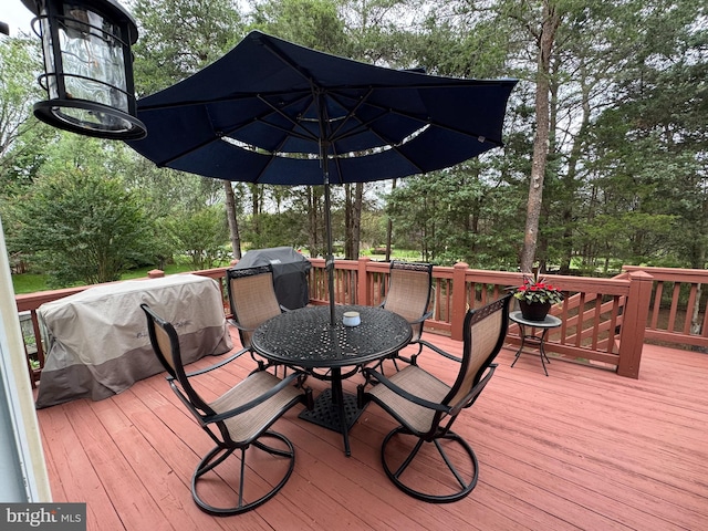 9111 Dartford Pl, Bristow, VA 20136 - wooden deck featuring outdoor dining space, a grill, and view of wooded area