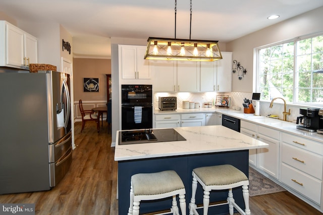 9111 Dartford Pl, Bristow, VA 20136 - kitchen with black appliances, tasteful backsplash, white cabinetry, and recessed lighting
