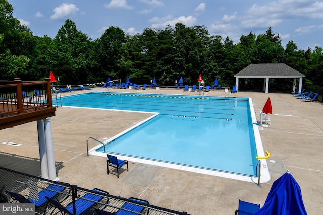 9111 Dartford Pl, Bristow, VA 20136 - community pool with a patio area and view of wooded area