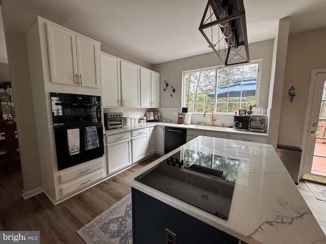 9111 Dartford Pl, Bristow, VA 20136 - kitchen with black appliances, backsplash, wood finished floors, and white cabinets
