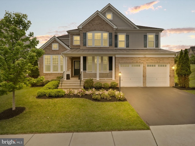 42350 Stonemont Cir, Ashburn, VA 20148 - traditional-style home with a standing seam roof, brick siding, covered porch, a garage, and asphalt driveway