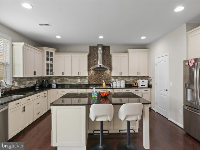 42350 Stonemont Cir, Ashburn, VA 20148 - kitchen with wall chimney exhaust hood, stainless steel appliances, a sink, decorative backsplash, and glass insert cabinets