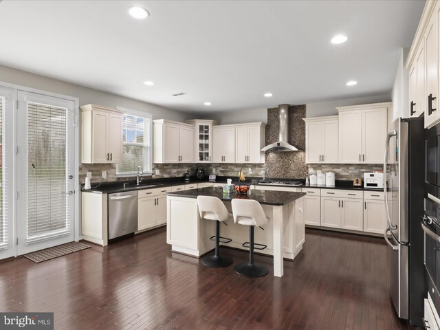 42350 Stonemont Cir, Ashburn, VA 20148 - kitchen with wall chimney exhaust hood, stainless steel appliances, a sink, decorative backsplash, and recessed lighting