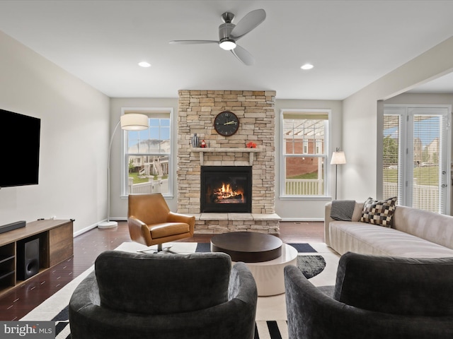 42350 Stonemont Cir, Ashburn, VA 20148 - living area featuring a stone fireplace, healthy amount of natural light, a ceiling fan, baseboards, and recessed lighting