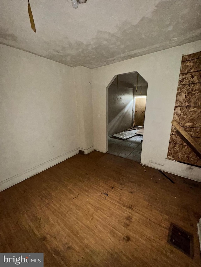 328 S Payson St, Baltimore, MD 21223 - unfurnished room featuring wood finished floors and arched walkways