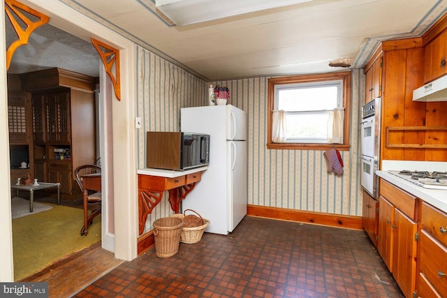 559 Righter St, Philadelphia, PA 19128 - kitchen featuring white appliances, wallpapered walls, light countertops, brick patterned floors, and baseboards
