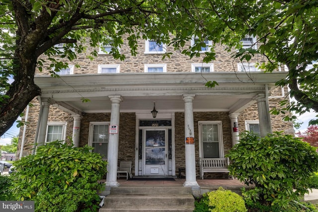 559 Righter St, Philadelphia, PA 19128 - doorway to property featuring a porch and stone siding