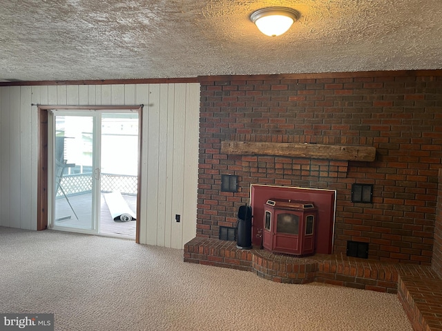 517 S Wayne St, Lewistown, PA 17044 - unfurnished living room featuring a wood stove, carpet, a textured ceiling, and wood walls