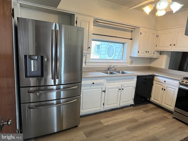 517 S Wayne St, Lewistown, PA 17044 - kitchen with stainless steel appliances, a sink, white cabinets, and light countertops