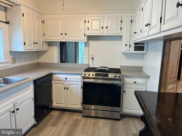 517 S Wayne St, Lewistown, PA 17044 - kitchen featuring gas stove, dishwasher, white cabinets, and light wood-type flooring