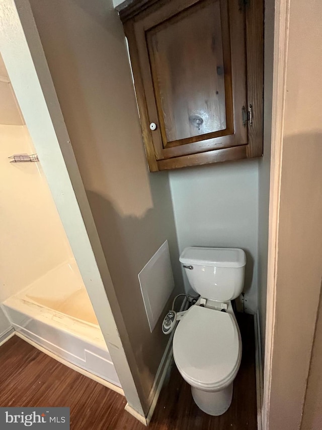 517 S Wayne St, Lewistown, PA 17044 - bathroom featuring wood finished floors, toilet, a shower stall, and baseboards