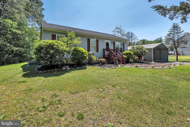 859 Columbia Ave, Newfield, NJ 08344 - view of front of home featuring a detached carport, a front lawn, an outdoor structure, and central air condition unit