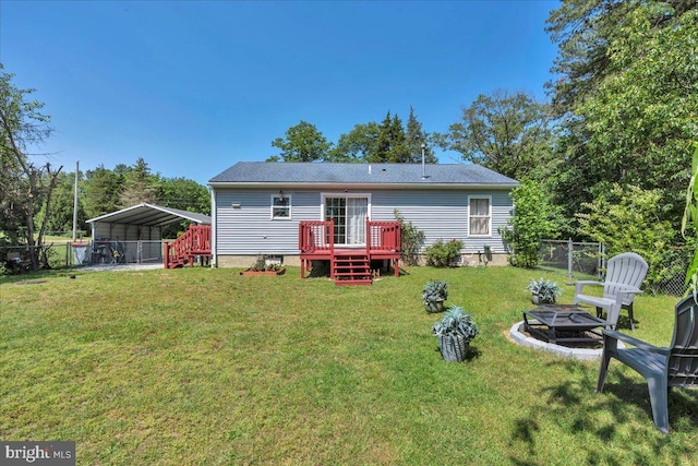 859 Columbia Ave, Newfield, NJ 08344 - rear view of house featuring a fire pit, a carport, and a wooden deck