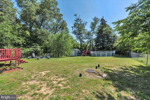 859 Columbia Ave, Newfield, NJ 08344 - view of yard featuring view of wooded area, an outdoor pool, and a deck